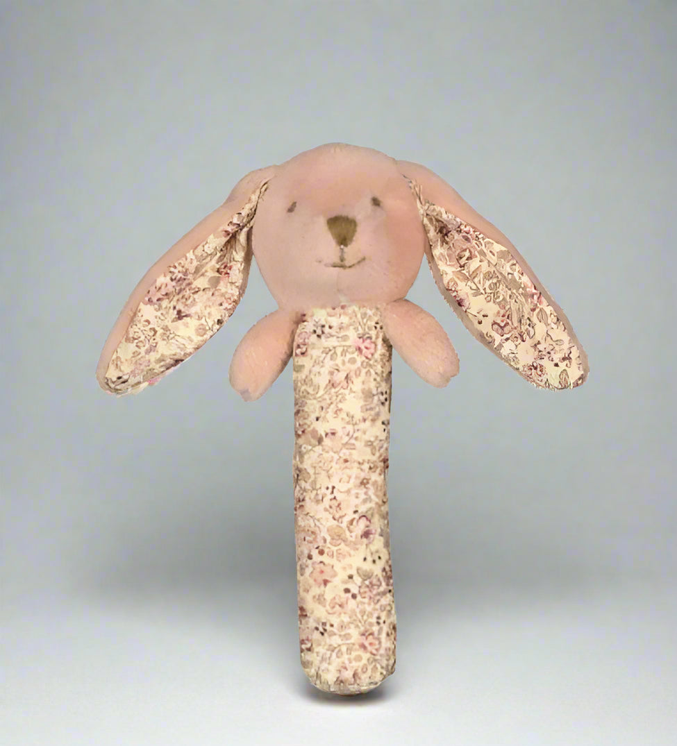 Floral-patterned plush bunny rattle on a white background