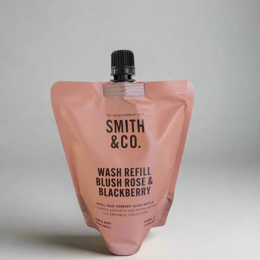 Pink wash refill pouch with 'Smith & Co.' branding on a black surface.