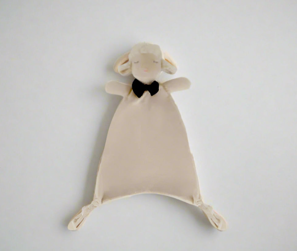 Plush toy sheep with a black bow tie on a light gray background