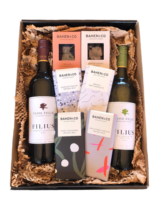 A gift hamper box containing bottles of Vasse Felix wine and various chocolate bars from Bahen & Co.