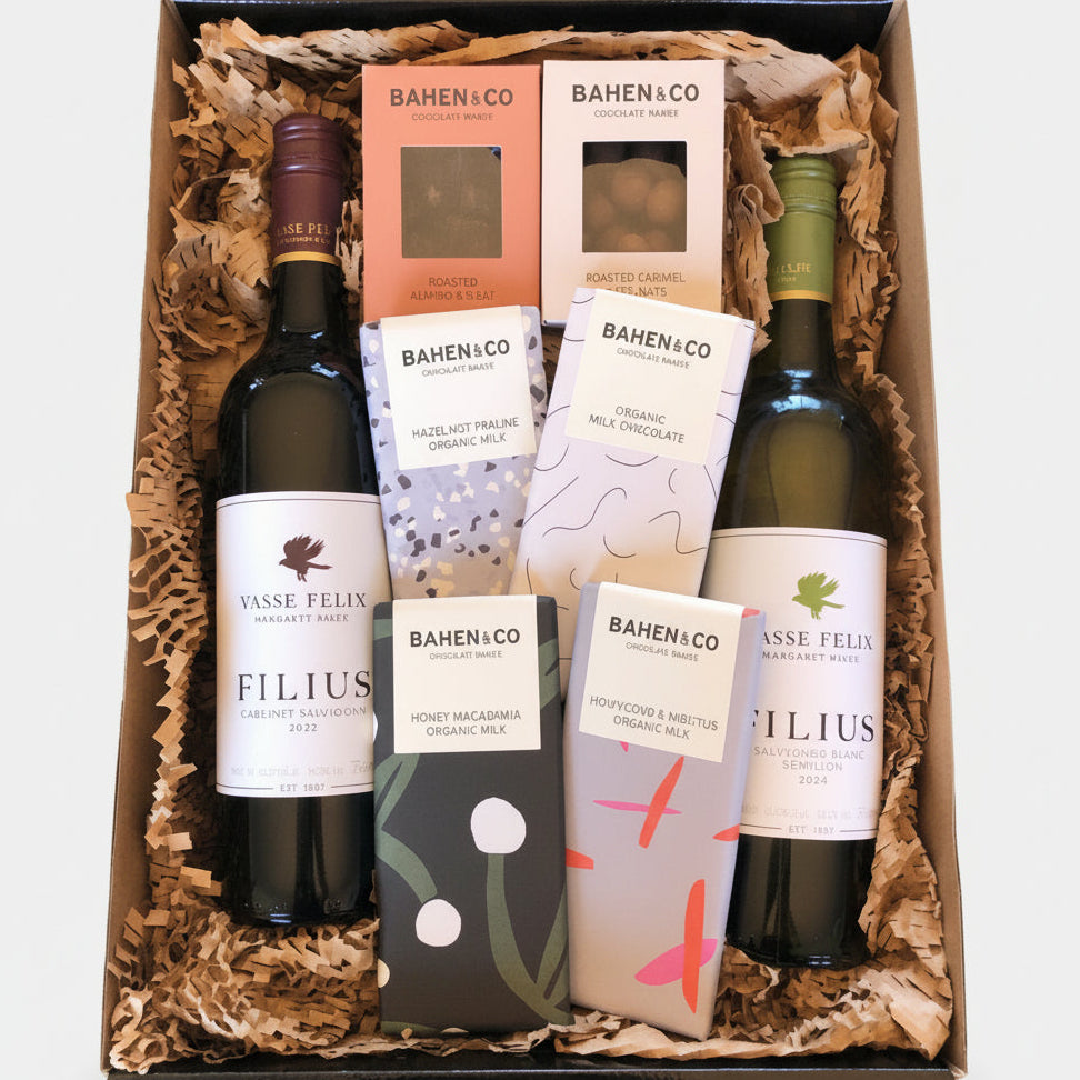 A gift hamper box containing bottles of Vasse Felix wine and various chocolate bars from Bahen & Co.