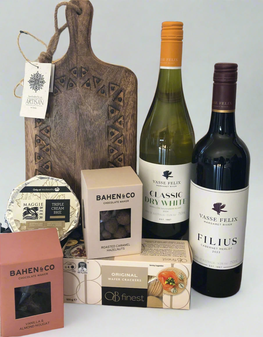 An assortment of gourmet food items and wine bottles, including bottles of Vasse Felix wine, a chopping board, and packages of Bahen & Co. nuts and Ob Finest crackers.