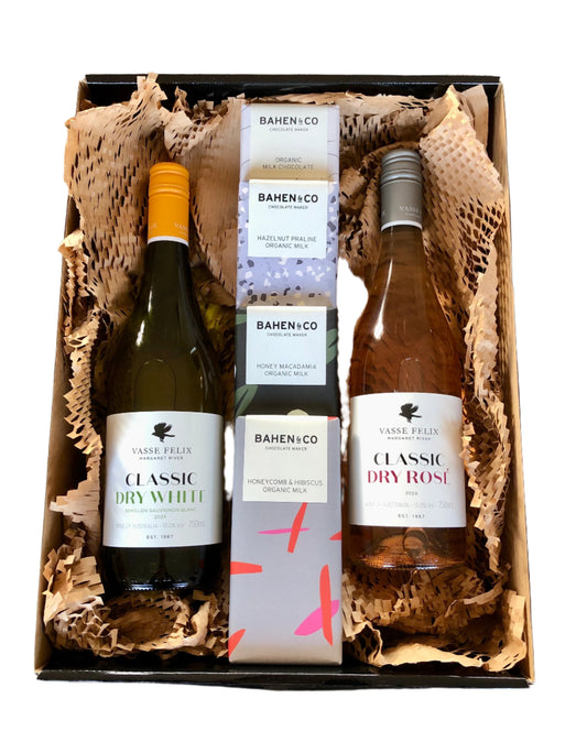 A hamper box with Vasse Felix wine bottles, along with some Bahen & Co. chocolates, presented in a nestled position with bubble wrap. The bottles are labeled and appear to be of high quality.