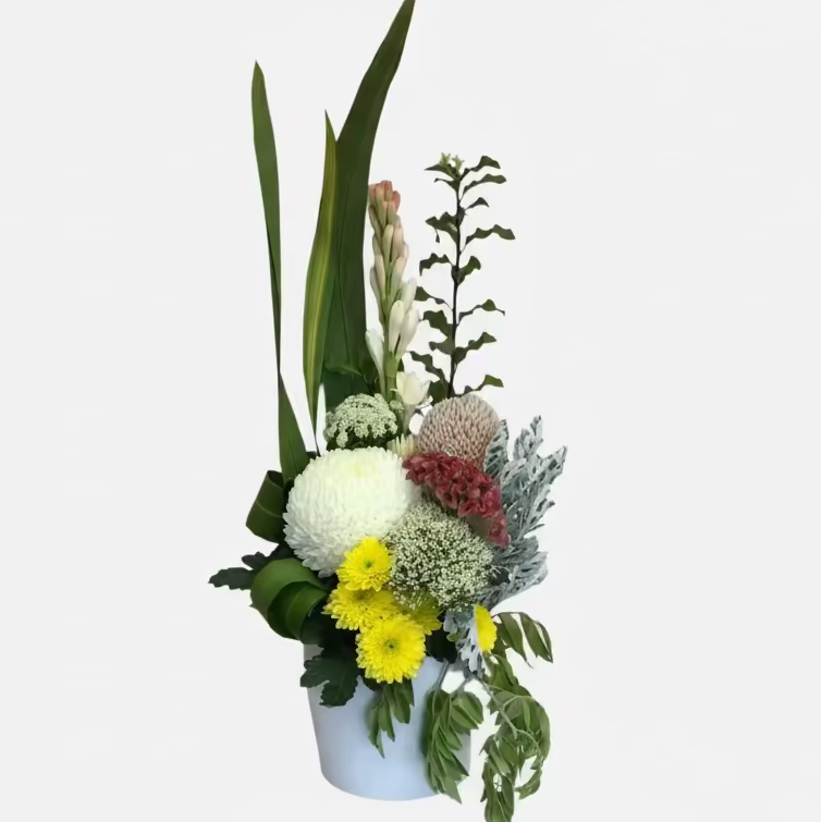 Floral arrangement in a white container on a light gray background