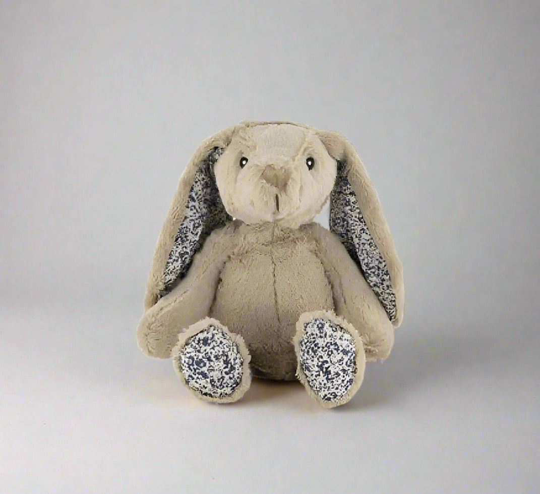Plush toy rabbit with floral details on a white background