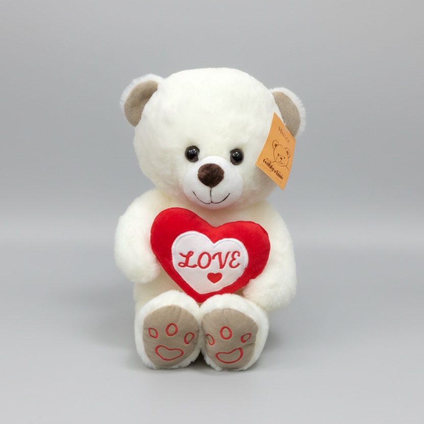 White teddy bear with a red heart that says 'LOVE' on a gray background