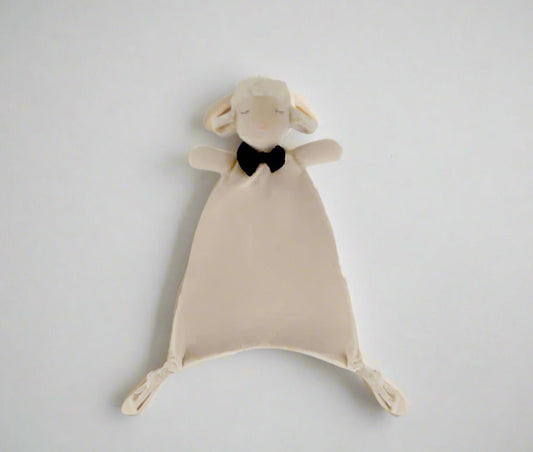 Plush toy sheep with a black bow tie on a light gray background