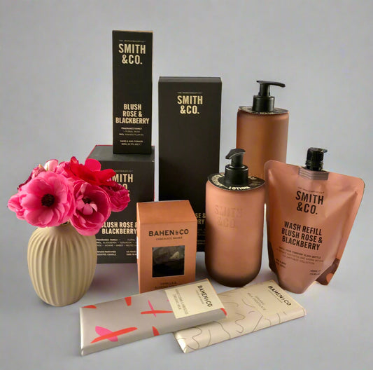 Smith & Co. skincare products with flowers on a white surface