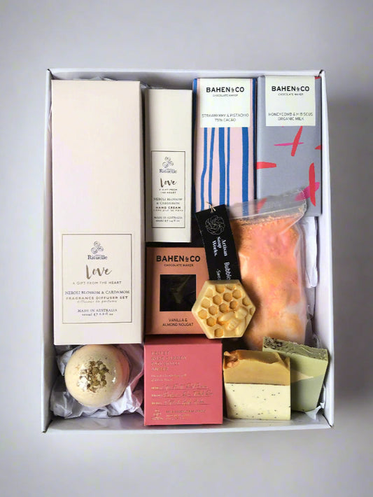 hamper with skincare products, chocolates, candle and diffuser