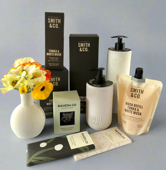 Smith & Co. products including bottles, boxes, and a vase on a white surface.