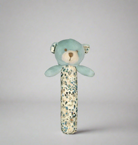 Blue teddy bear rattle with floral pattern on a white background
