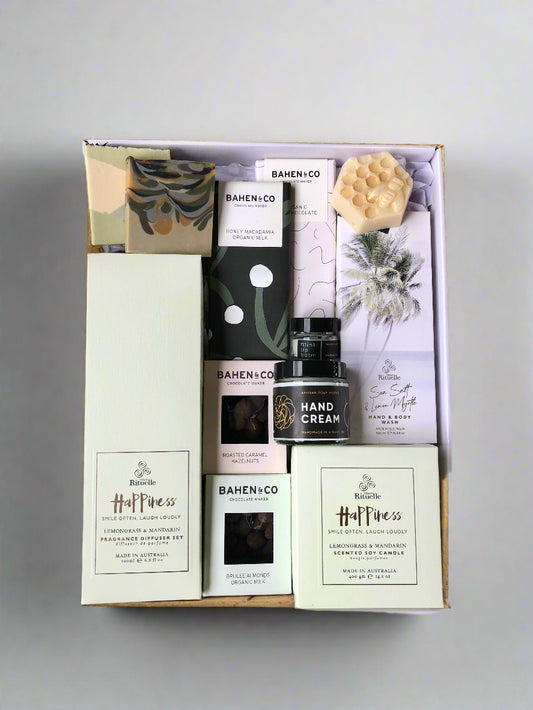 Gift set with soap bars, chocolates, candle, diffuser, hand cream, lip balm and hand wash.