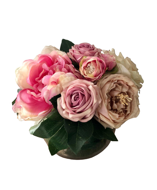 pink and beige flowers in a fishbowl vase