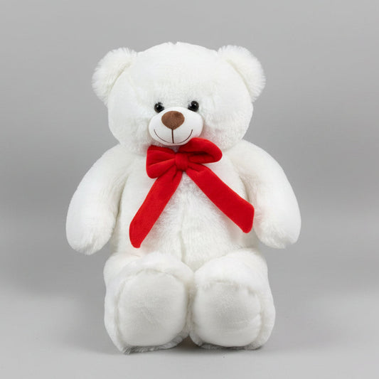 White teddy bear with a red bow on a gray background